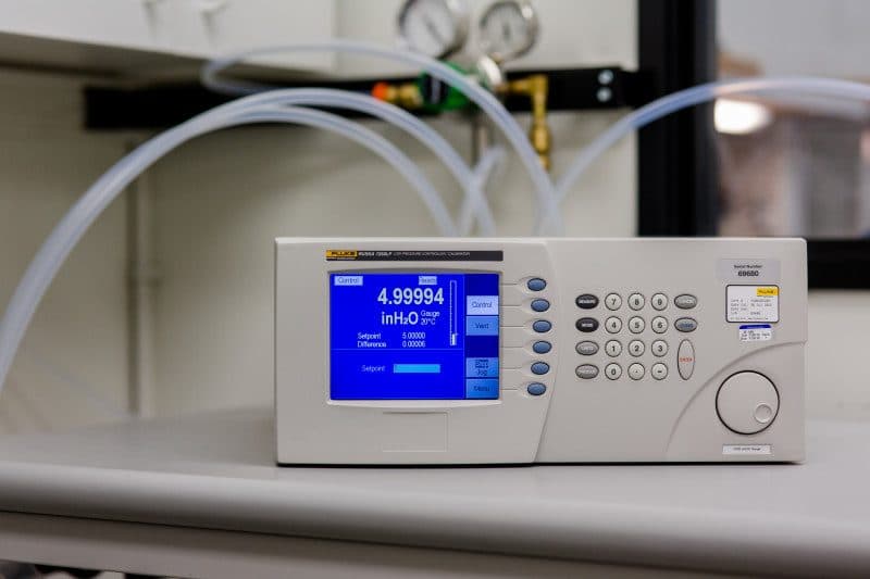 A precision pressure controller alongside comparator equipment