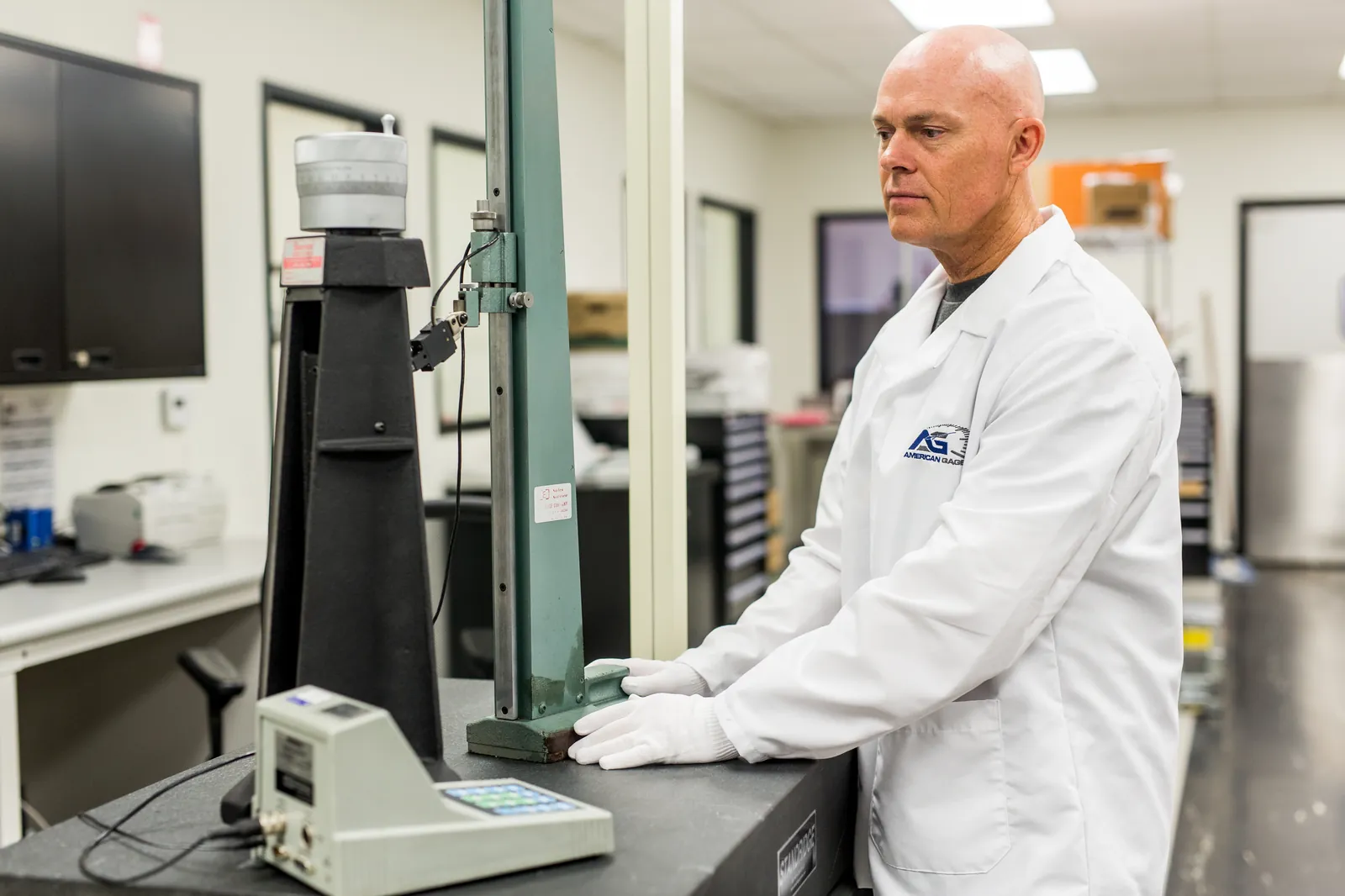 American Gage technician calibrating a height gauge on a granite surface plate