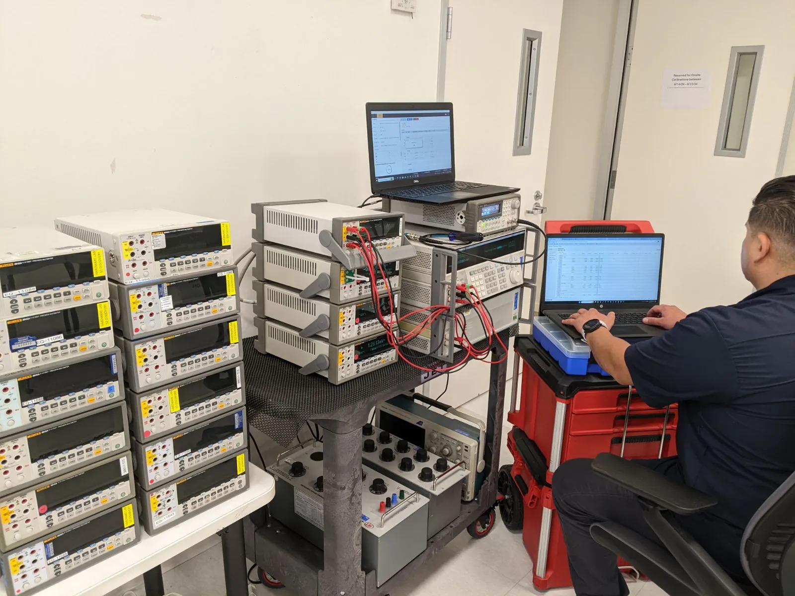 American Gage technician calibrating a fleet of precision multimeters during an on-site service visit